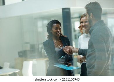 Welcoming A New Member To The Team. Cropped Shot Of Businesspeople Shaking Hands In An Office.