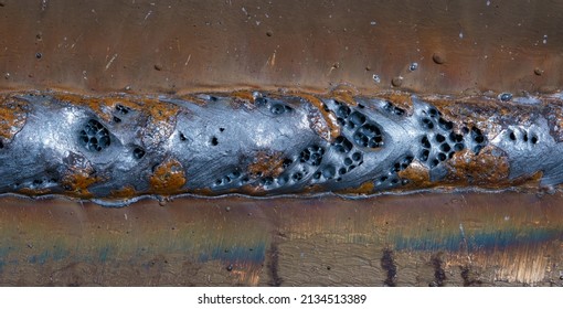 Weld defect. The work was carried out using semi-automatic arc welding. MIG welding. - Shutterstock ID 2134513389