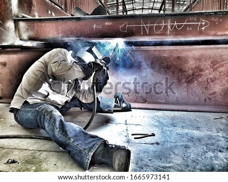 Welder during bridge construction workhard.