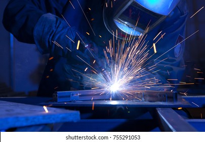 Welder erecting technical steel. Industrial steel welder in factory technical