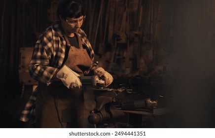 Welder, factory and metal worker woman with grinder and industrial machine in warehouse of blacksmith. Steel, labor and professional with welding skills and gear with manufacturing and maintenance - Powered by Shutterstock