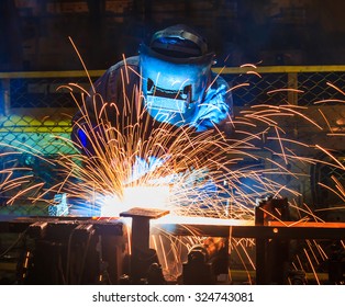 welder Industrial automotive part in factory - Shutterstock ID 324743081