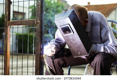 Welder Old Man Welding A Fence