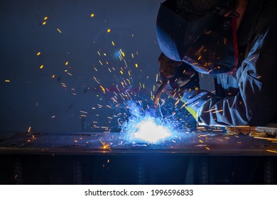 The welder performs metal construction welding with semi-automatic electric arc welding.