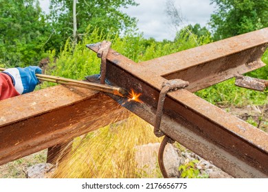 Welder Using Acetylene Torch Cuts Old Metal Structure. Flying Hot Metal Splashes.