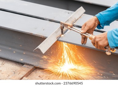 Welder using an oxy-acetylene cutting torch in construction site. - Powered by Shutterstock