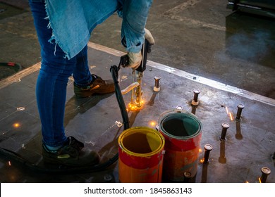 A Welder Is Using A Stud Welding Machine To Weld Stud Bolt On Steel Plate, At Industrial Factory.