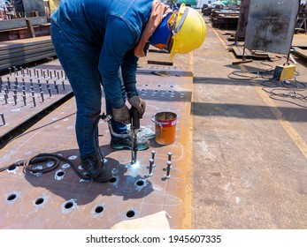 Welder Is Using A Stud Welding Machine To Weld Stud Bolt On Steel Plate, At Industrial Factory.