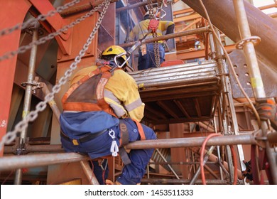 Welder Wearing Safety Helmet, Fall Arrest, Fall Restraint PPE Harness Prevention Which Attached  With Retractable Shock Absorber Device Lanyard On The Back Of His Safety Harness Loop While Welding