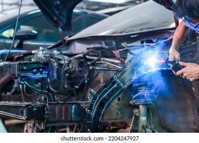 A Welder Is Welding A Damaged Car Frame.