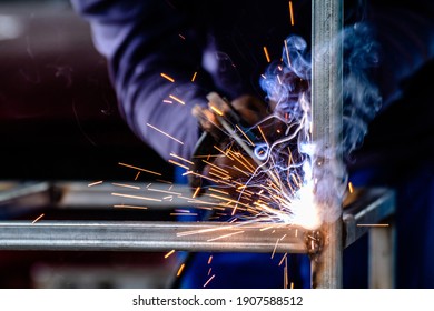 welder and welding sparks, construction and metal work industrial concept, metal welding with sparks, laborer or labor day concept - Shutterstock ID 1907588512