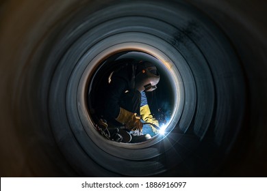 Welder is welding in the spiral welded large pipe. The spiralweld manufacturing process is one of the most cost effective ways to produce steel pipe. Spiralweld pipe is manufactured from steel coil.