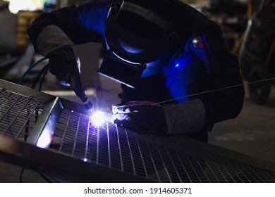 Welder is welding the steel in the factory. - Shutterstock ID 1914605371