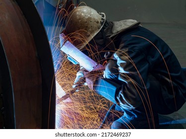 The welder is welding steel plates