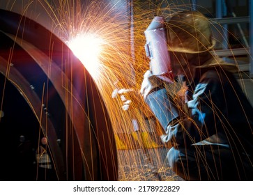The welder is welding steel plates