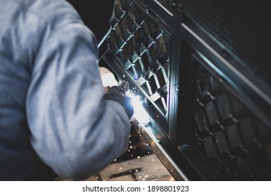 Welder Welds The Steel Gear Racks To Gate Before Setting Up Automated Gate Operator. Professional Service Of Installation And Maintenance Of Automatic Cantilever Sliding Gate