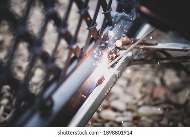 Welder Welds The Steel Toothed Rack To Gate Before Setting Up Automated Gate Operator. Professional Service Of Installation And Maintenance Of Automatic Cantilever Sliding Gate.