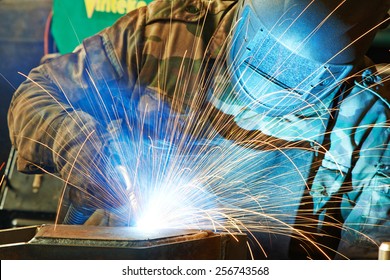 welder working with electrode at semi-automatic arc welding in manufacture production plant - Powered by Shutterstock