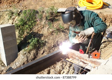 Welder Working Outside In The Metal Construction