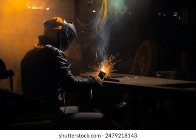 welder works with an electrode to produce a custom part. welding with sparks - Powered by Shutterstock