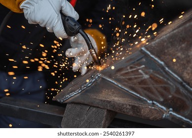 Welder works with precision, sparks flying as metal parts are fused together in a workshop. Safety gear is worn, contrasting sparks adding a dynamic touch to the scene - Powered by Shutterstock