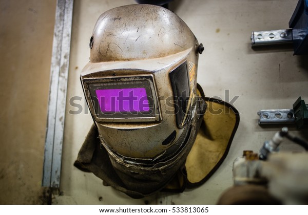 A welders helmet in a car\
garage