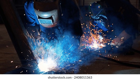 Welders at work in metal industry, welding metal construction. Close-up shot lots of sparks in the factory - Powered by Shutterstock