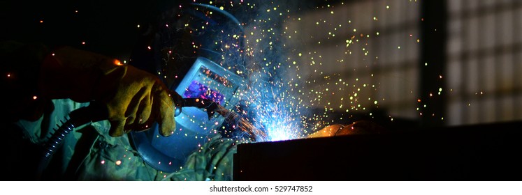 Welders working at the factory made metal	