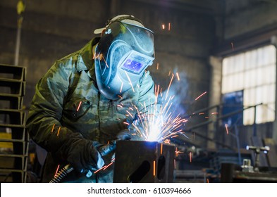 Welders working at the factory made metal