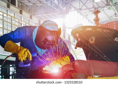 Welding Arc Worker With Spark Weld Factory At Shipbuilding And Ship Repairing Industrial, Wear Equipment Protective For Safety In Shipyard.