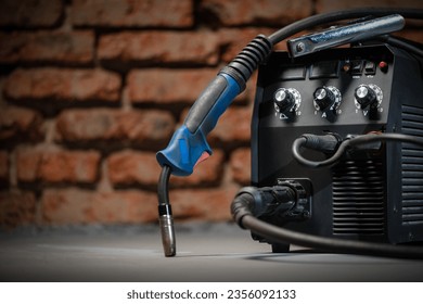 Welding concept background. Semi automatic welding machine close up on the floor background with copy space. 