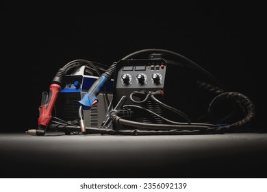 Welding concept background. Semi automatic welding machine and plasma cutter close up on the floor background with copy space. Metalwork concept.