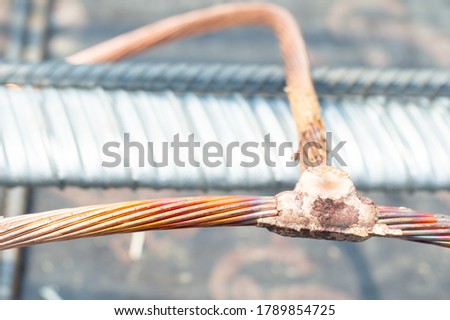 Welding copper ground wire on ground rod.Welding copper ground wire.Connect copper grounding lightning protection system. With the melting
