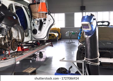 Welding Equipment In A Car Repair Station, Helmet Hanging On A Gas Tank, No People