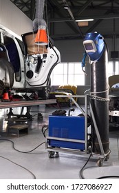 Welding Equipment In A Car Repair Station, Helmet Hanging On A Gas Tank, No People