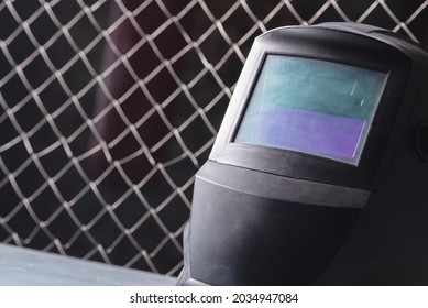 Welding Helmet On The Workbench Close Up Abstract Background.