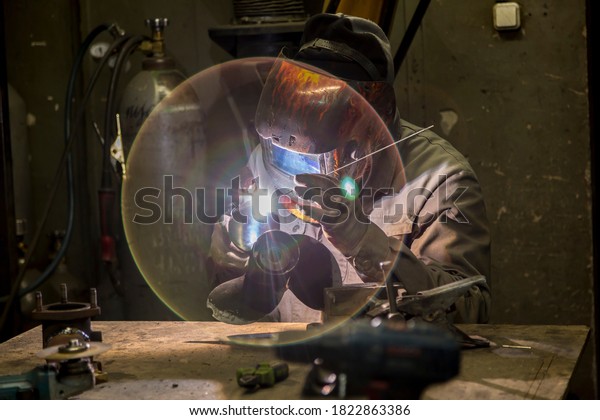 Welding a large car\
radiator with a gas\
torch
