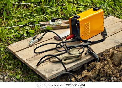 Welding Machine And Protective Helmet. Tools For Electric Welding Close Up.