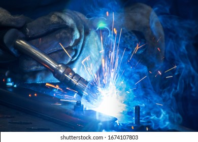 The Welding Machine At Work On A Blue Background