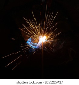 Welding metal with a bunch of sparks. Welding flame with sparks. Welding mass holder.  - Powered by Shutterstock