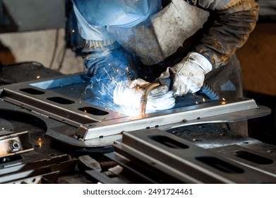 Welding and metal processing at a factory in the river by production workers - Powered by Shutterstock