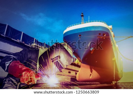 Welding MIG worker with spark weld factory at shipbuilding and ship Repairing industrial, wear equipment protective for safety concept on forward ship in shipyard background and vintage tone