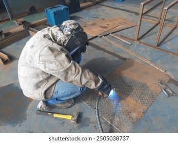 Welding on steel plates in the fabrication workshop. - Powered by Shutterstock