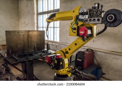 A Welding Robot In A Production Room Of A Mechanical Plant. The Picture Was Taken In Russia