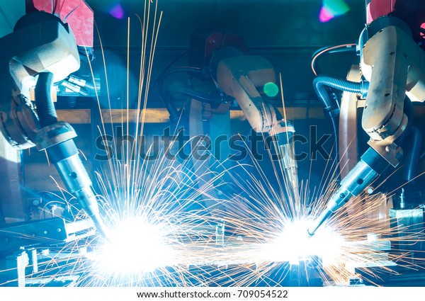 Welding robots movement in a car factory,\
automotive parts\
industry