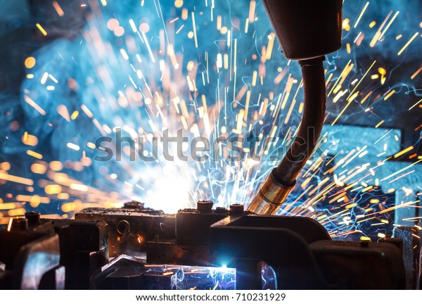 Welding robots movement in a car factory,\
automotive parts\
industry