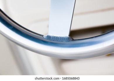 Welding seam on the stainless steering wheel of an expensive motor yacht.