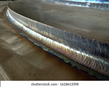 Welding of stainless steel with argon arc welding. Welding TIG. Color welding seam.