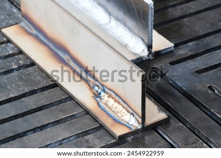 Welding steel beams completed in process shielded metal arc welding.close up weld on a steel beams for a new heat line.The welded joint on a steel beams,high pressure line
