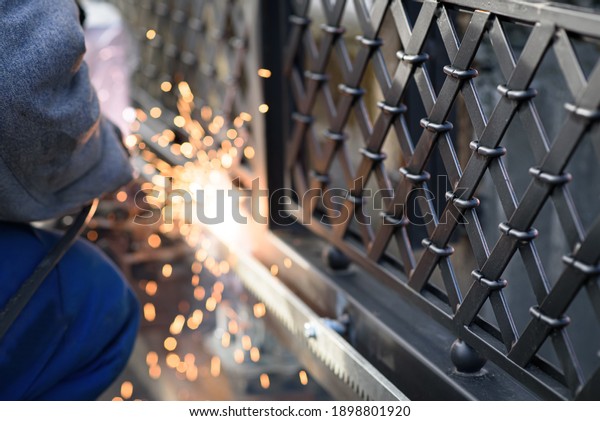 Welding\
the steel gear racks to gate. Last phase before setting up an\
automated gate operator. Professional service of installation and\
maintenance of automatic cantilever sliding\
gate.